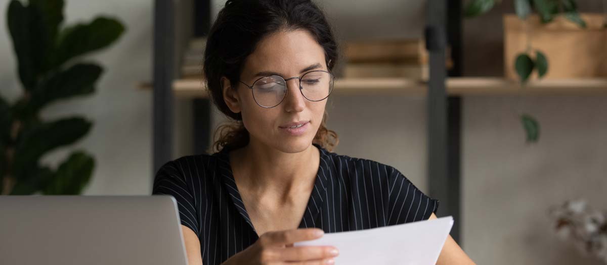 Lady checking over her CV. iStock.com/fizkes